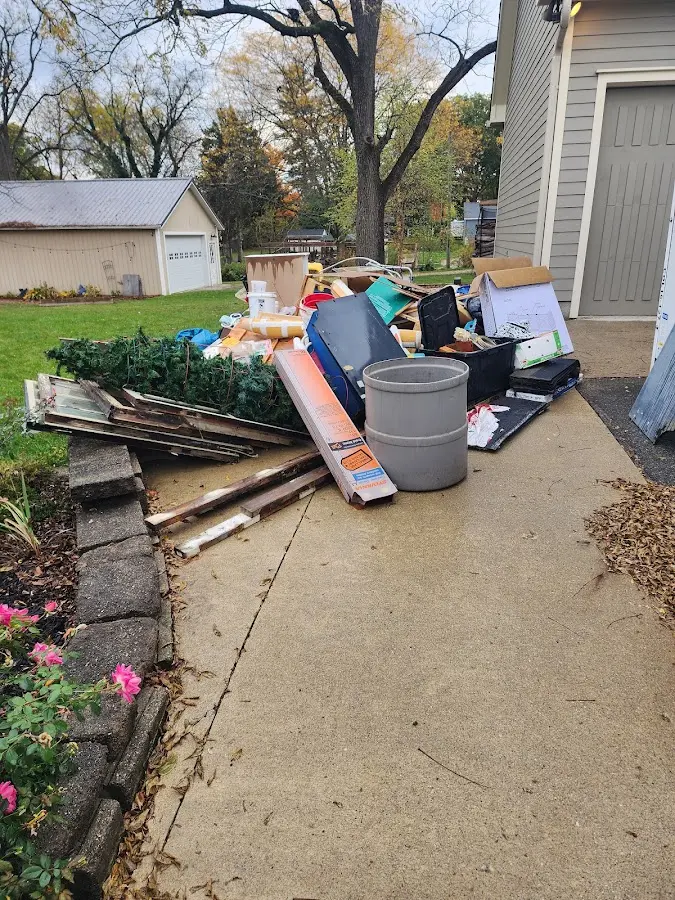 Dumpster being loaded with debris for 3 Yard Dumpster Rental in Dundee
